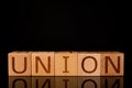 Teamwork concept, Wood cube block with word Ã¢â¬ÅUNIONÃ¢â¬Â. Royalty Free Stock Photo